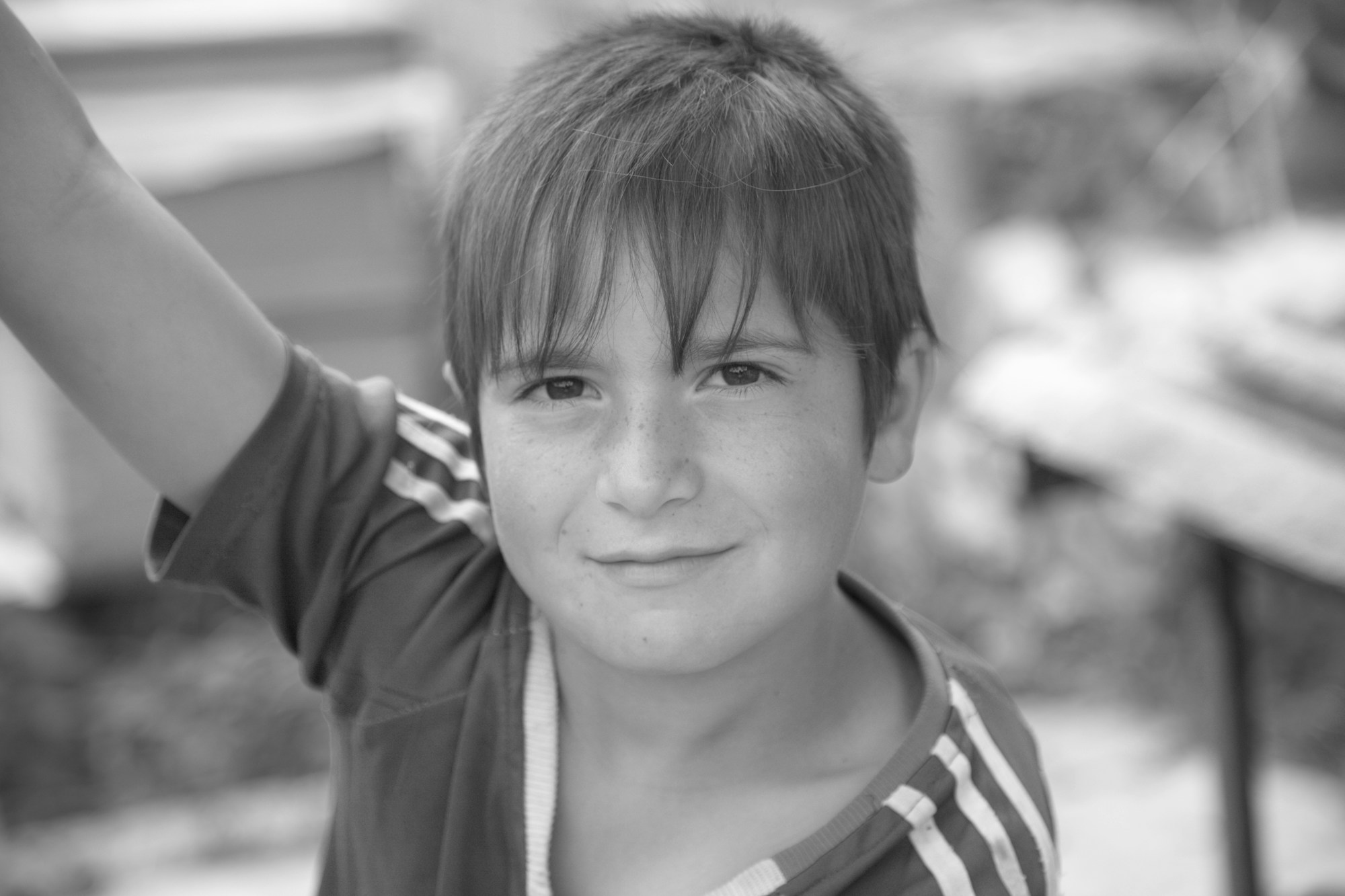 A smiling boy in Armenia waving at the camera