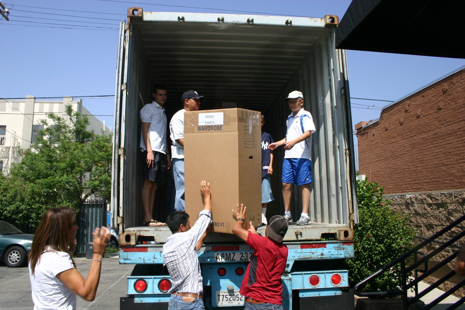 Volunteers passing boxes into a shipping container bound for Armenia