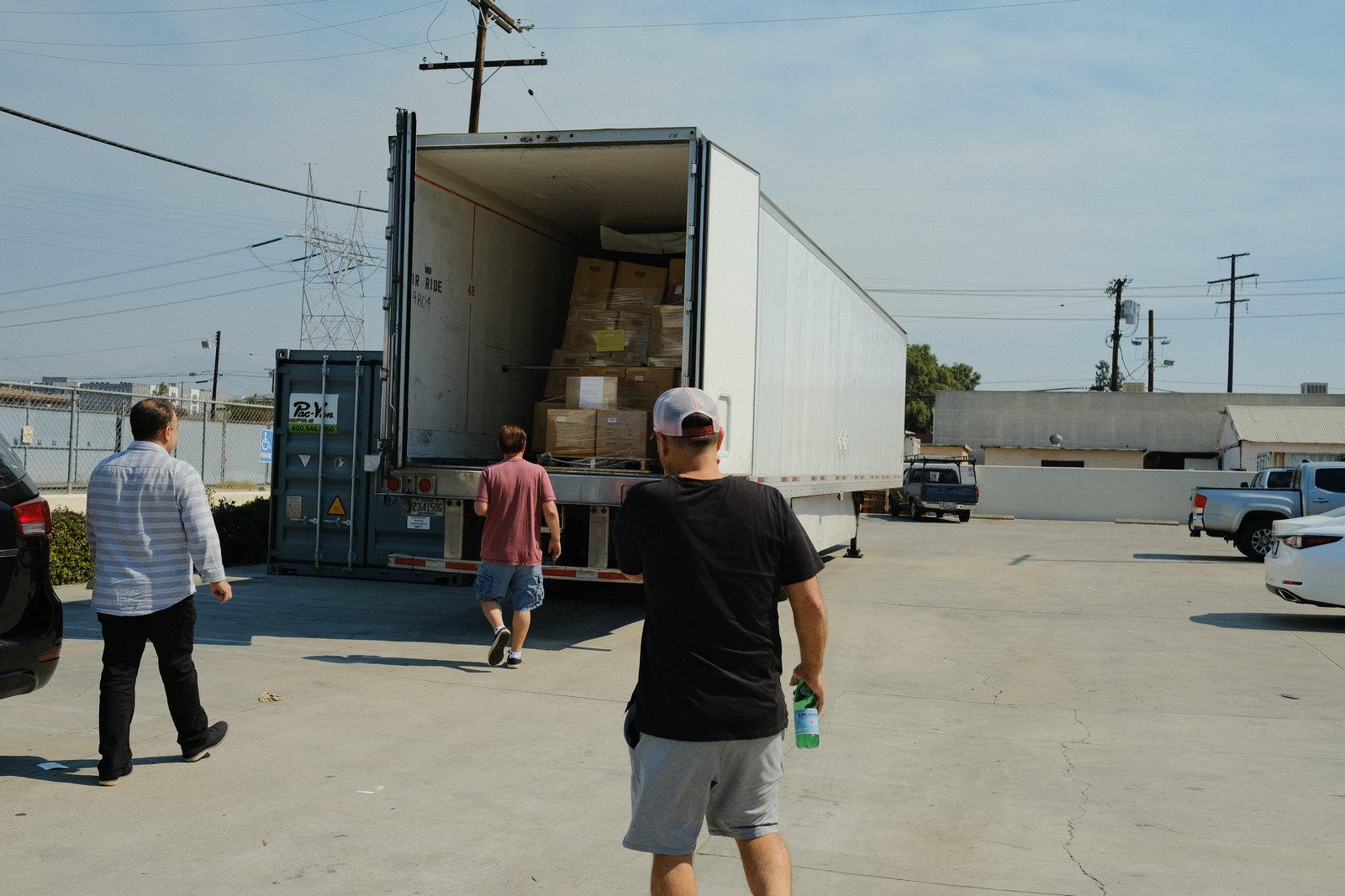 Volunteers walking to a truck loaded with relief boxes