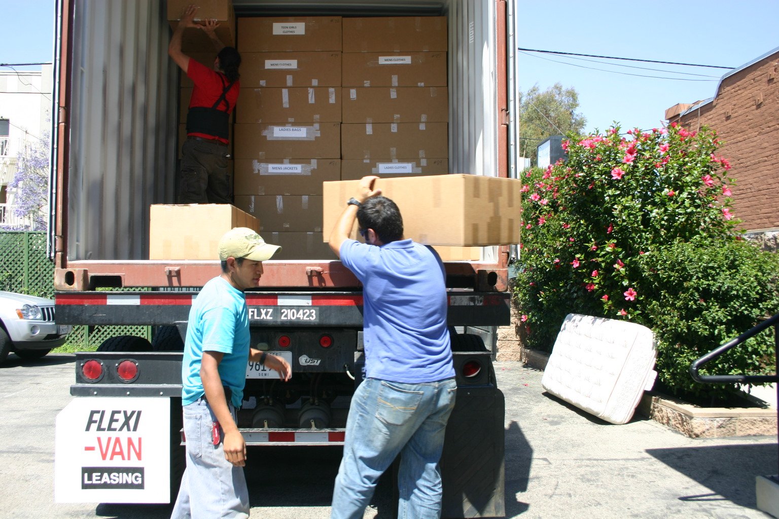 Volunteers passing boxes up into a shipping container