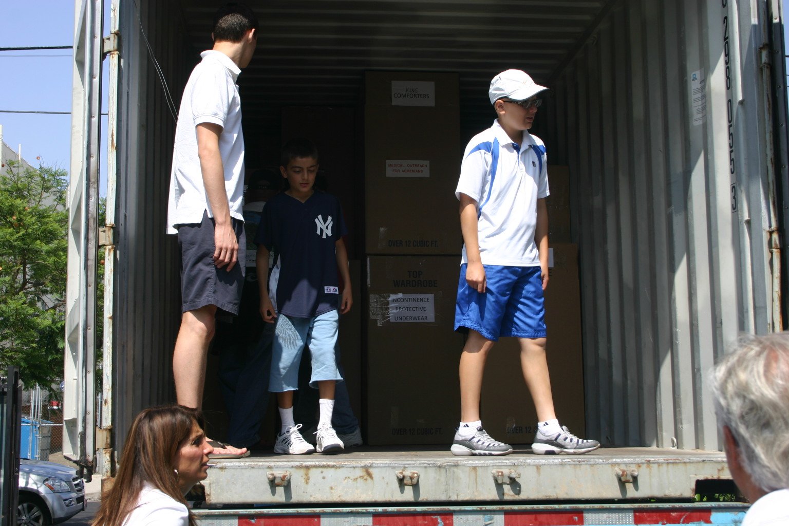 Young volunteers inside a shipping container bound for Armenia